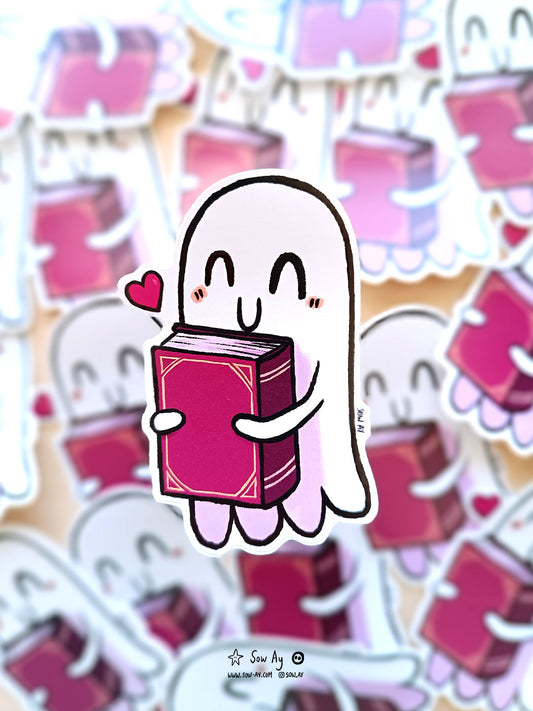 petit fantôme tout content qui tient contre lui un grand livre rouge